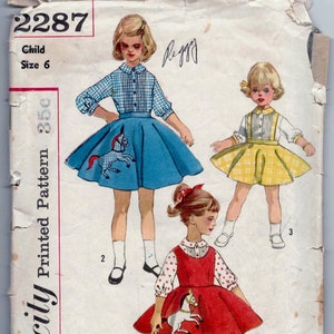 May include: Vintage Simplicity sewing pattern for a child's dress with a horse applique. The pattern number is 2287 and the size is 6. The pattern includes three different dress styles.