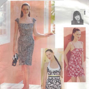 May include: Vogue Attitudes sewing pattern featuring three dress designs. One dress is a midi-length with a square neckline and a paisley print. The other two are mini-dresses, one with a floral print and spaghetti straps, and the other with a halter top.