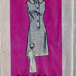 May include: A vintage sewing pattern for a sleeveless dress with a button-up front. The pattern is printed on pink paper and features a black and white checkered design. The pattern is for size 16 1/2 and is labeled "9069 - SIZE 16 1/2".