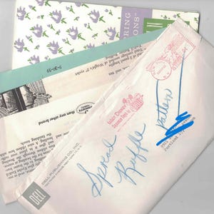 May include: A collection of vintage paper sewing patterns and instructional leaflets from Dell Publishing Co. featuring a floral print, black and white illustrations, and text including Walt Disney Squeeze Toys by Dell and handwritten blue ink notes.