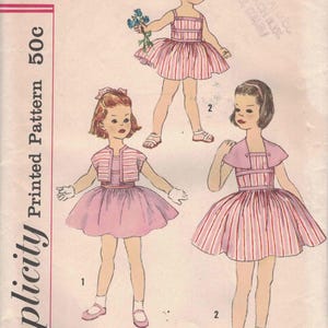 May include: Vintage Simplicity pattern 2519, size 6. The illustration shows three little girls in dresses with striped bodices and skirts. One girl holds flowers. The pattern is marked 50c.