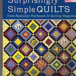 May include: A book cover titled Surprisingly Simple QUILTS From Australian Patchwork & Quilting Magazine. The cover features a grid of diamond-shaped fabric patches in various colors and patterns, including yellow, blue, red, and cow motifs.