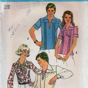 May include: Simplicity sewing pattern number 6957 for a large size shirt. The pattern shows three people wearing different styles of shirts. One shirt is a light blue shirt with vertical stripes, another is a pink shirt with vertical stripes, and the third is a white shirt with a lace-up front.