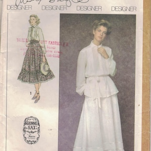 May include: Vintage Simplicity sewing pattern 8907, size 12 Miss. Features two dress designs. One design includes a skirt with a floral pattern and a white blouse. The other design is a white dress with a ruffled skirt. Designed by Cisal Broyles.