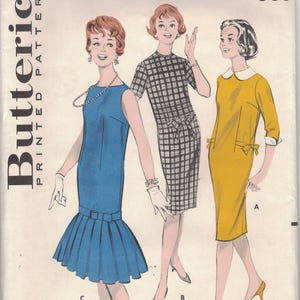 May include: Vintage Butterick sewing pattern envelope featuring illustrations of three dresses. The envelope displays the pattern number 8749, bust size 32, and size 12. The price is 50 cents.
