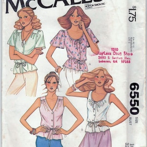 May include: A vintage sewing pattern for a women's blouse with a tie at the waist. The pattern is from McCall's and is size 10, bust 32 1/2 inches. The pattern shows four different styles of the blouse.