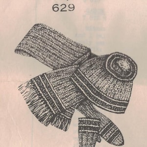 May include: An illustration of a knitted scarf, hat, and gloves set. The scarf has fringe on the end. The hat is a beanie style. The gloves are mittens. The text "Laura Wheeler Designs 629" is at the top.