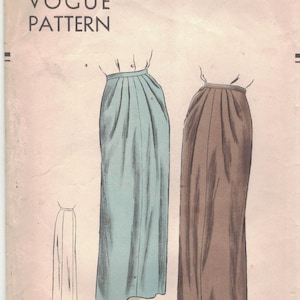 May include: Vintage Vogue pattern envelope featuring illustrations of two long skirts in blue and brown. The envelope includes the text "Vogue Pattern" and measurements of 30-inch waist and 39-inch hip.