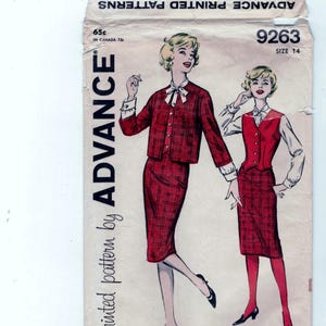 May include: Vintage sewing pattern for a two-piece outfit. The pattern is for size 14 and is from Advance Printed Patterns. The pattern features a red and white plaid skirt and jacket with a white blouse.