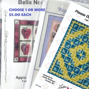May include: Four quilt patterns featuring a variety of designs. The patterns are titled "Apple", "Rag", "Please Don't Eat the Stars", and "St Table". The patterns are printed on white paper with a blue and white background. The patterns are available for $5.00 each.