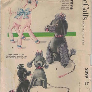 May include: Vintage McCall's sewing pattern for stuffed toy dogs. The pattern features illustrations of a pink lamb and three poodle designs in black and gray. The pattern includes size information: Lamb A about 16" tall, Mama Poodle B about 14" tall, and Baby Poodle C about 8.5" tall.