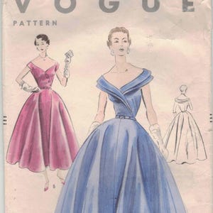 May include: Vintage Vogue pattern envelope featuring illustrations of elegant dresses. The envelope displays the Vogue logo, pattern number 7874, and size information. The dresses are in shades of pink and blue, with a classic 1950s style.