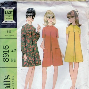 May include: Vintage McCall's sewing pattern for a misses' dress in three versions. The pattern number is 8916, size 14, bust 34. The pattern is labeled "Easy" and "Dressmaker Tested".