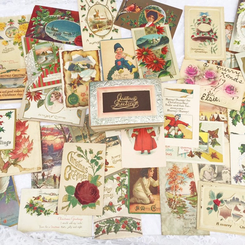 May include: A collection of vintage Christmas postcards featuring various festive scenes, including winter landscapes, snowmen, and greetings. The postcards are in various colours, including red, green, and white.