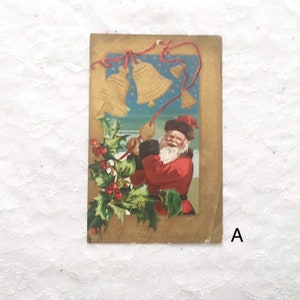 May include: Vintage Christmas postcard featuring a cartoon Santa Claus in a red suit and fur hat ringing golden bells with red ribbons. The background is a blue sky with white stars and a holly border.