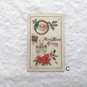 May include: Vintage Christmas postcard featuring a portrait of Santa Claus in a red hat and white beard, surrounded by holly and poinsettia flowers. The text "Merry Xmas Greeting" is written in cursive.