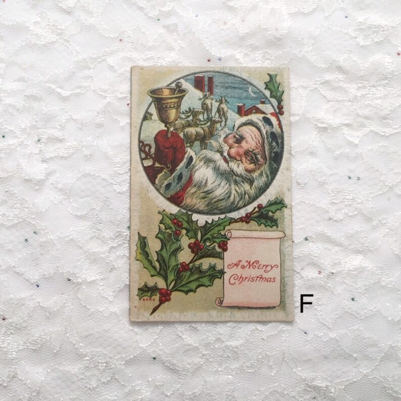 May include: Vintage Christmas postcard featuring a round illustration of Santa Claus holding a bell, with reindeer and a snowy landscape in the background. The text "A Merry Christmas" is written on a scroll with holly leaves.