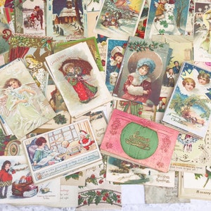 May include: A collection of vintage Christmas postcards featuring various festive scenes, including children, angels, and winter landscapes. The postcards are in a variety of colours and styles, with some featuring gold accents. The text on the postcards includes greetings such as "Merry Christmas" and "Greetings".