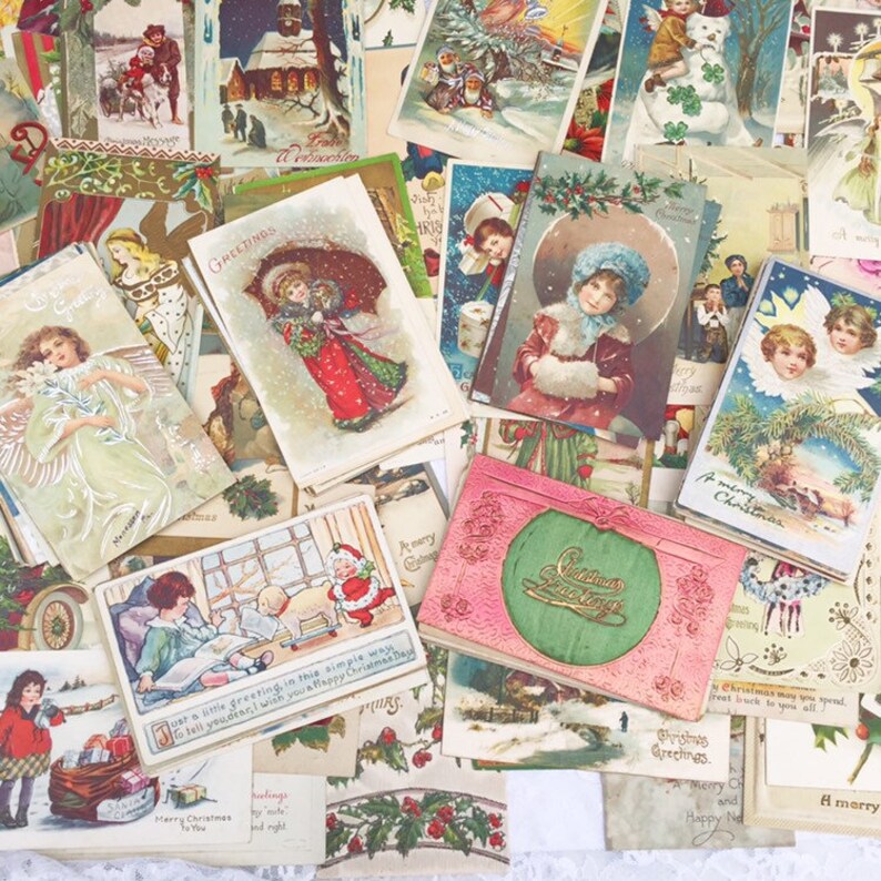 May include: A collection of vintage Christmas postcards featuring various festive scenes, including children, angels, and winter landscapes. The postcards are in a variety of colours and styles, with some featuring gold accents. The text on the postcards includes greetings such as "Merry Christmas" and "Greetings".