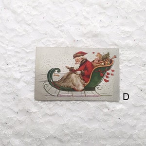 May include: Vintage Christmas postcard featuring a red-suited Santa Claus riding in a green sleigh with a small elf. The postcard has a white background with a dotted pattern and the text "Merry Xmas".