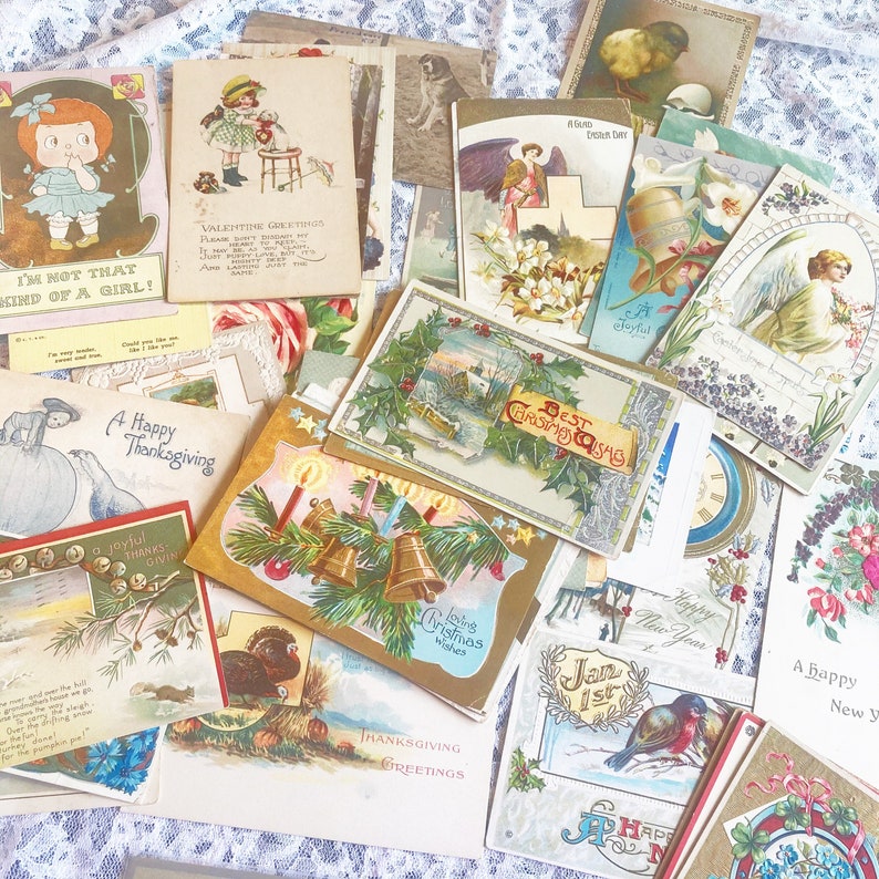 May include: A collection of vintage postcards featuring various holiday themes, including Christmas, Thanksgiving, and New Year's. The postcards are decorated with festive illustrations, such as holly, bells, and snowflakes. Some of the postcards have handwritten messages.