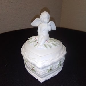 The Francisco Music Box Company Cupid blowing a kiss Heart shaped lidded trinket box