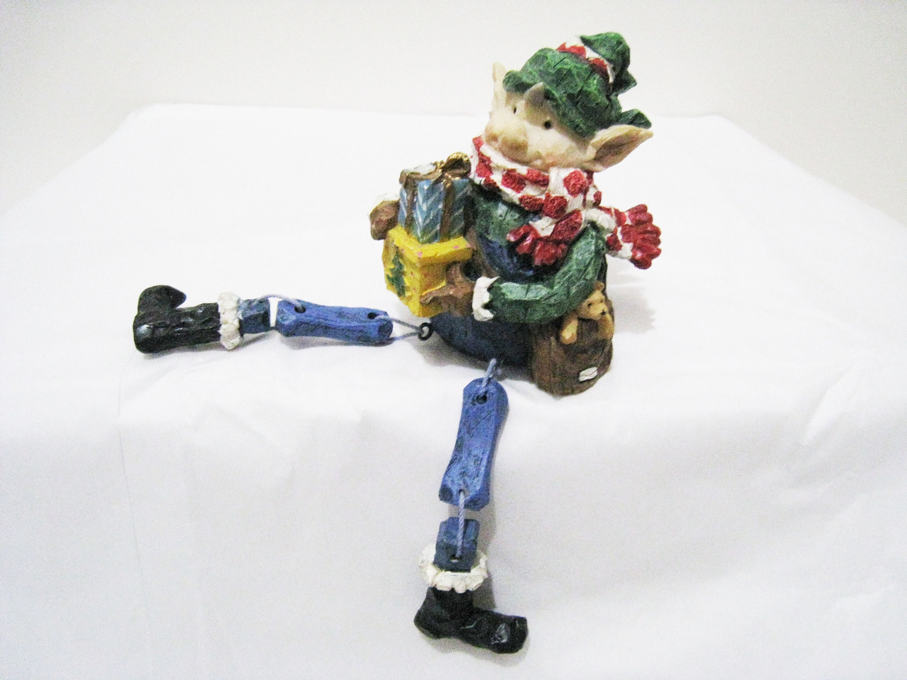 Christmas Shelf Sitter elf Holding Christmas Packages Wearing a Scarf