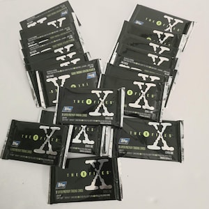21 paquets de cartes à collectionner série un X files