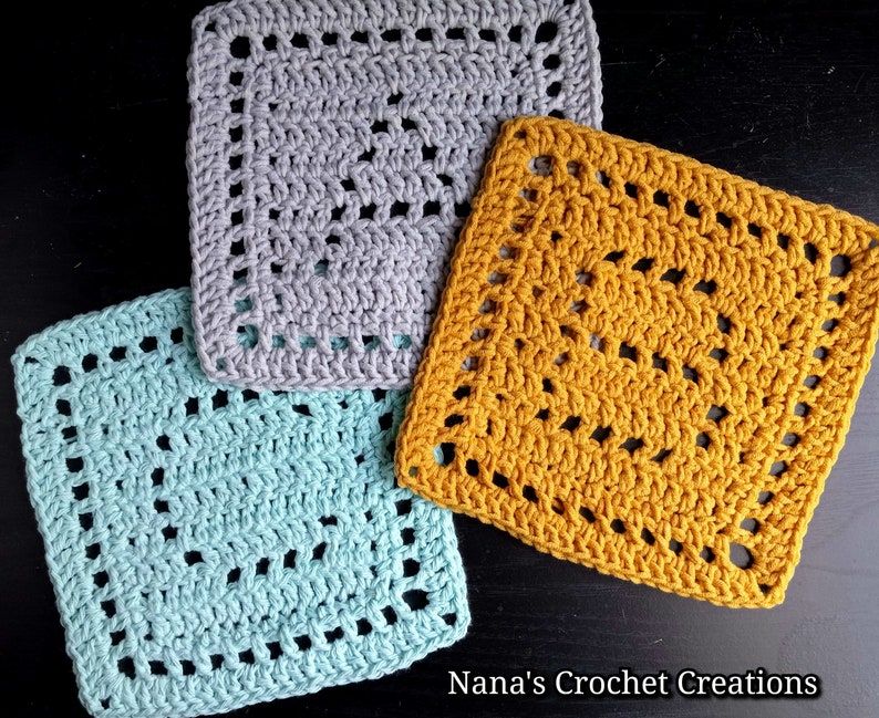 May include: Three crocheted squares in different colors: light blue, gray, and mustard yellow. The squares have a lacy pattern with open spaces.
