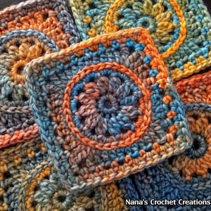 May include: Close-up of colorful crocheted squares with a circular pattern in the center. The squares are made with a variety of shades of blue, orange, and brown yarn.