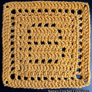 May include: A square crochet granny square with a repeating pattern of holes. The square is made with a mustard yellow yarn.