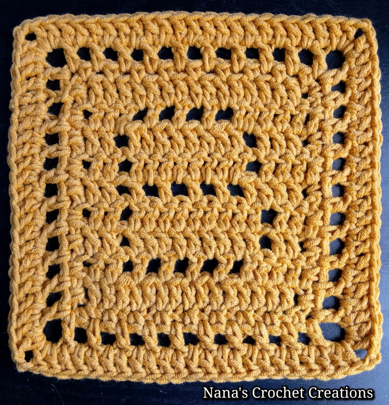 May include: A square crochet granny square with a repeating pattern of holes. The square is made with a mustard yellow yarn.