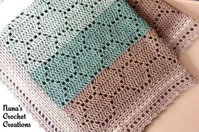 May include: A crocheted blanket featuring a repeating geometric pattern in horizontal stripes of light mint green, soft beige, and pale lavender. The edges are finished with a delicate scalloped border. The text Nana's Crochet Creations is visible.