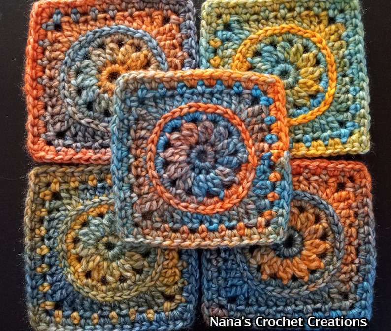 May include: Five crocheted squares in shades of blue, orange, and brown with a circular pattern in the center of each square. The squares are arranged in a circular pattern with the text "Nana's Crochet Creations" at the bottom.