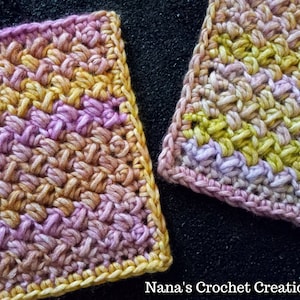 Puede incluir: Dos cuadrados tejidos a crochet, uno en tonos de rosa y amarillo, el otro en tonos de verde y morado. Ambos cuadrados tienen un borde amarillo. "Nana's Crochet Creations" está escrito en la esquina inferior derecha de la imagen.