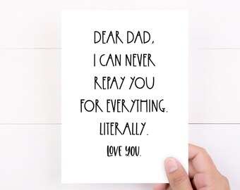 May include: A white greeting card with black text that reads "DEAR DAD, I CAN NEVER REPAY YOU FOR EVERYTHING. LITERALLY. LOVE YOU." The card is held by a hand against a white wooden background.
