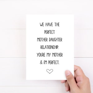 May include: A white card with black text that reads "We have the perfect mother daughter relationship. You're my mother & I'm perfect." A small heart is at the bottom of the card.