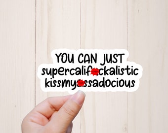 May include: White sticker with black text that reads "You can just supercalifrackalistic kissmyassadocious".