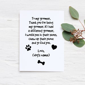 May include: A white greeting card with black text that reads "To my groomer, Thank you for being my groomer..." with paw prints, a heart, and a bone graphic. Eucalyptus sprigs are in the background.