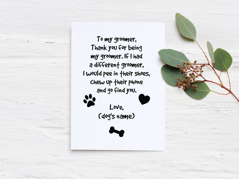 May include: A white greeting card with black text that reads "To my groomer, Thank you for being my groomer..." with paw prints, a heart, and a bone graphic. Eucalyptus sprigs are in the background.