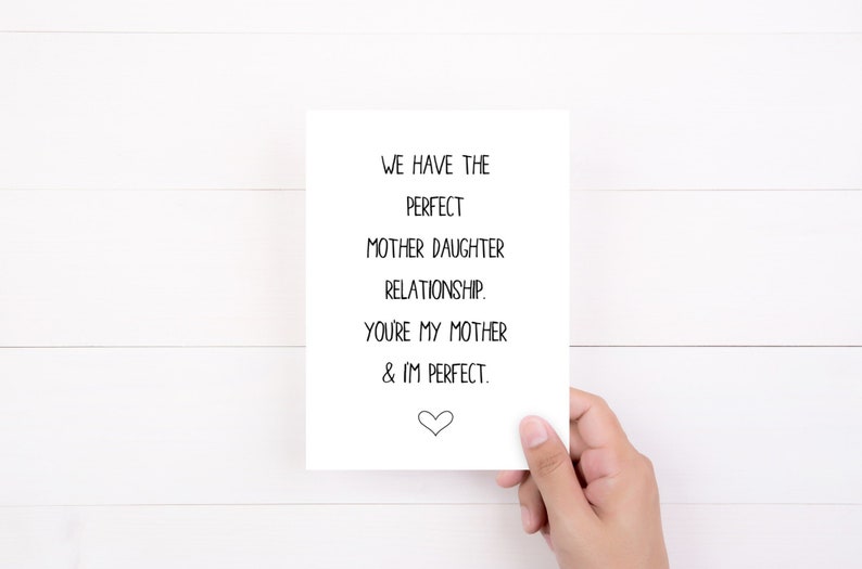 May include: A white card with black text that reads "We have the perfect mother daughter relationship. You're my mother & I'm perfect." A small heart is at the bottom of the card.