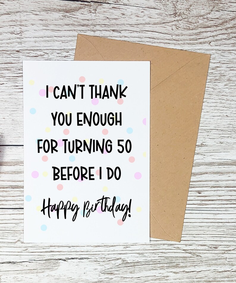 Może przedstawiać: Biała kartka urodzinowa z napisem "I CAN'T THANK YOU ENOUGH FOR TURNING 50 BEFORE I DO Happy Birthday!" obok brązowej koperty. Karta ma kolorowe kropki.