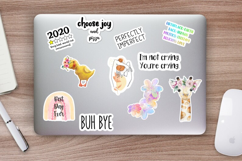 May include: A collection of colorful stickers featuring various designs and phrases, including a rainbow with the text "Best Day Ever", a yellow duckling with flowers, a giraffe with a flower crown, a hand with the text "Perfectly Imperfect", and the text "Choose Joy and Pizza".