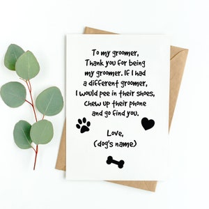 May include: A white greeting card with black text, a paw print, a heart, and a dog bone illustration. The card is in a brown envelope and has a sprig of green leaves. The text reads: "To my groomer, Thank you for being my groomer..."