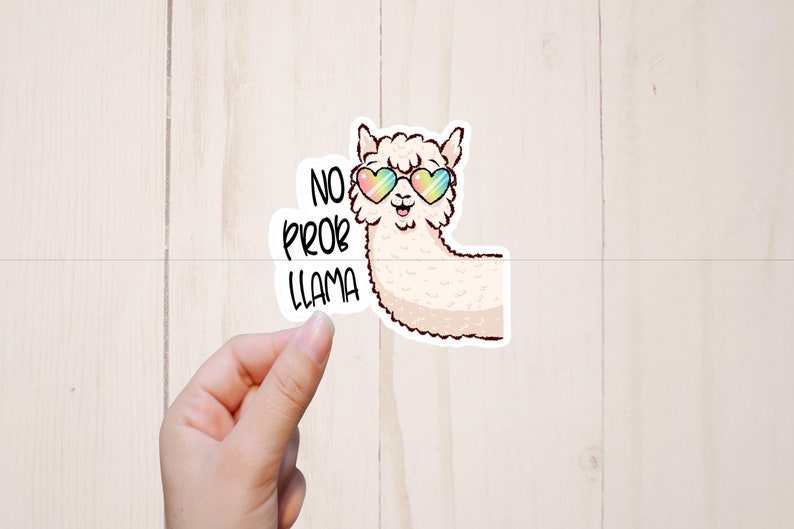May include: A white llama wearing rainbow heart-shaped sunglasses with the text "No Prob Llama" in black lettering.