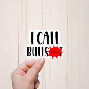 May include: White sticker with black text that reads "I call bull", a red starburst with the word "oops!" in white text.