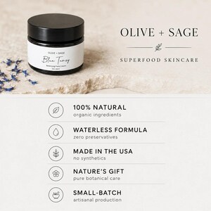 Infographic for Olive and Sage Blue Tansy Balancing Face Cream highlighting 100 percent natural ingredients, a waterless formula, made in the USA, nature's gift pure botanical care, and small-batch artisanal production.