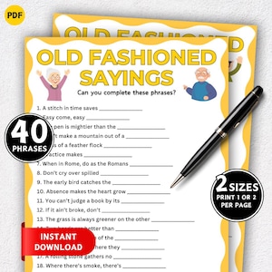 May include: A printable PDF game titled "Old Fashioned Sayings" with fill-in-the-blank phrases. The design features yellow borders, illustrations of elderly people, and the text "Instant Download". A black pen rests on the game sheet.