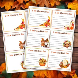 May include: Two sheets of Thanksgiving-themed cards with the text "I am thankful for." Each card features fall-themed illustrations, including pumpkins, leaves, gnomes, and an owl. The cards have a lined space for writing.