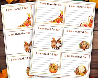 May include: Two sheets of Thanksgiving cards with the text "I am thankful for." Each card features autumn-themed illustrations, including pumpkins, leaves, gnomes, and an owl. The cards have a lined space for writing.